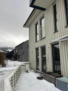 a house with snow in front of it at Modern & Central - Free Parking & Stylish Decor in Vossevangen