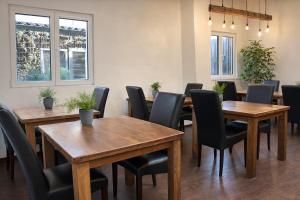 a dining room with wooden tables and chairs at S'Matt Bob in Feldkirch