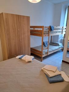 a room with two bunk beds and towels on the floor at Green & Blue House in Valbrona