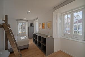 a room with a loft bed and a desk at Boomerang d'O Século in Ericeira