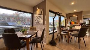 a restaurant with wooden tables and chairs and a window at Hotel Pitsakis in Tolo +70 photos