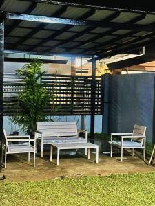 a group of benches sitting under a pavilion at Jumira Staycation in Tagum
