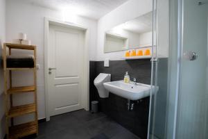 a bathroom with a sink and a toilet at KiRoom Willsbach 2 und 3 in Obersulm +25 photos