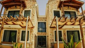 a facade of a building with wooden balconies at Ultava Koru Suites in Datca +8 photos