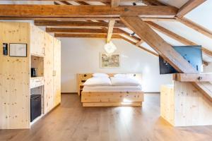 a bedroom with a bed in a room with wooden cabinets at Hotel Stern Chur in Chur