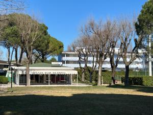 a large white building with trees in front of it at Villaggio Olimpia in Bibione
