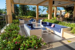 a patio with blue and white furniture and flowers at Holiday Village Türkiye in Dalaman