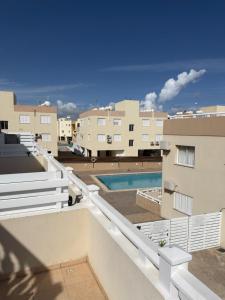 a view from the balcony of a building with a swimming pool at AquaSol Suite Modern 2BR with Shared Pool in Protaras