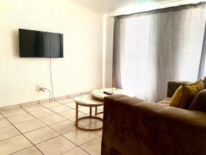 a living room with a couch and a table at Alldays Sunset Lodge Wilde Street in Alldays +2 photos