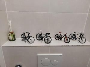 a row of bikes sitting on a shelf in a bathroom at Quiet spacious room in Amsterdam