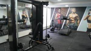 a fitness room with a gym with a mirror at Ocean Flat Tambaú in João Pessoa