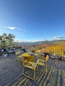 a deck with chairs and tables and a view at Sen Đá Home 2 in Da Lat