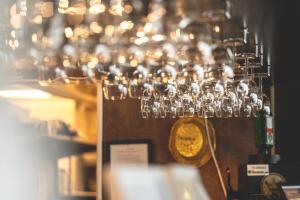 a chandelier of wine glasses hanging from a wall at Årsunda Strandbad in Årsunda +25 photos