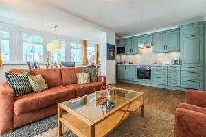 a living room with a couch and a table at Villa Eden II in Binz