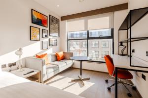 a bedroom with a couch and a table in a room at The SPACE To Stay Aparthotel in St. Andrews