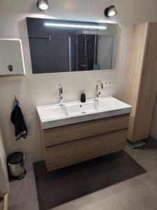 a bathroom with a white sink and a mirror at Quiet spacious room in Amsterdam +24 photos