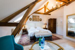 a bedroom with a bed and a glass table at Aux Charmes de Maintenon in Maintenon +47 photos