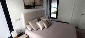 a bedroom with a white bed with three pillows at Villa Mojacar in Mojácar +58 photos