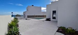a white house with a courtyard with a swimming pool at Villa Mojacar in Mojácar