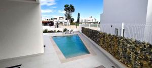 a swimming pool in the backyard of a house at Villa Mojacar in Mojácar