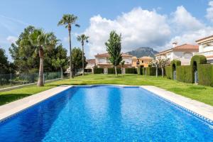 a swimming pool in front of a house at Brisa I Apartment in Montroig