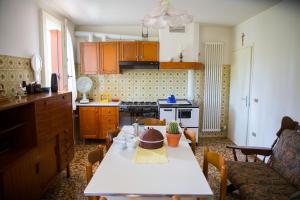 a kitchen with a white table and a kitchen with a tableablish at Casa dei Nonni in Mirabella