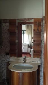 a bathroom with a sink and a mirror at Rosej Bed & Breakfast Putignano in Putignano +8 photos