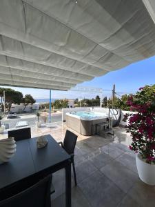 a patio with a table and a swimming pool at Casa Mazagón con vistas al mar in Mazagón