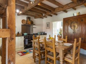 a kitchen with a wooden dining room table and chairs at 3 Bed in Belford oc-89518 in Belford