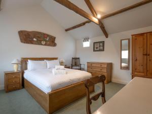 a bedroom with a bed and a dresser and a table at 3 Bed in Belford oc-89518 in Belford