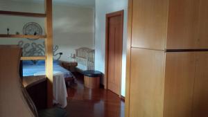 a bedroom with a bunk bed and a hallway at Rosej Bed & Breakfast Putignano in Putignano