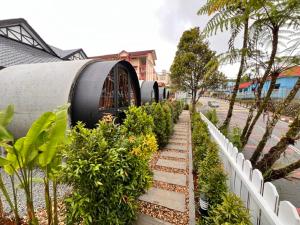 a row of plants next to a white fence at AURELIA Stay in Brinchang