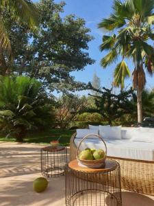 a table with a basket of fruit on a patio at Bandam Lodge in Ngaring
