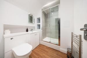 a white bathroom with a toilet and a shower at The Mortimer Arms in Romsey +84 photos