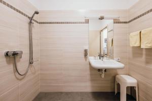 a bathroom with a sink and a shower at Pension RoBi in Harthofen +58 photos