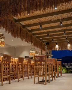 a group of chairs and tables in a restaurant at Este Elegant Suites & Villas - Adults Only in Kiotari