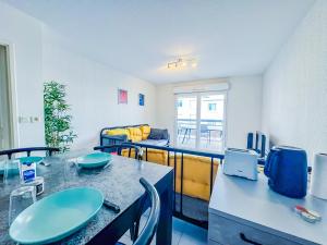 a room with a table and chairs and a couch at Apartment 4 pers avec Terrasse in Sète
