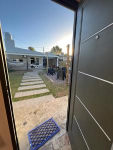 an open door of a house with a solar panel at MiniChino Casa Interna in Pehuajo +10 photos