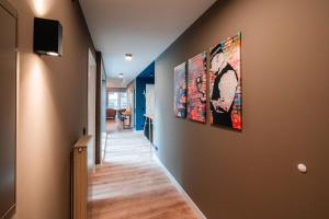 a hallway with two paintings on the wall at Marios Mansion in Leipzig