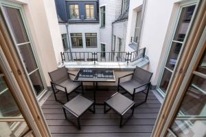 a balcony with a table and chairs on a building at Marios Mansion in Leipzig +6 photos