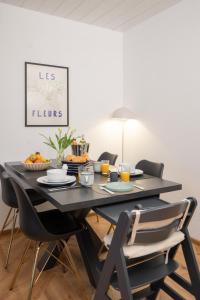 a dining room table with chairs and food on it at City Green Appartement in Bad Lippspringe +27 photos