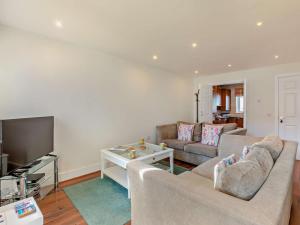 a living room with a couch and a tv at 3 Bed in Chathill oc-cn001 in Beadnell
