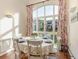 a dining room with a table and a large window at 3 Bed in Chathill oc-cn001 in Beadnell