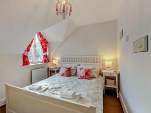 a bedroom with a bed and two windows at 3 Bed in Chathill oc-cn001 in Beadnell