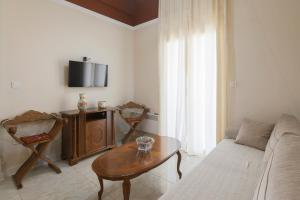 a living room with a couch and a table at vintege style apartment in Thessaloniki