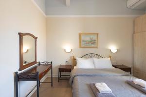 a hotel room with a bed and a mirror at vintege style apartment in Thessaloniki