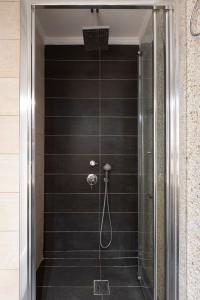 a walk in shower with a glass door at vintege style apartment in Thessaloniki +88 photos