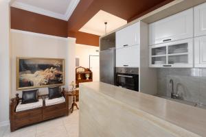 a kitchen with white cabinets and a counter top at vintege style apartment in Thessaloniki