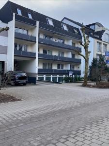 a parking lot in front of a large building at City Green Appartement in Bad Lippspringe