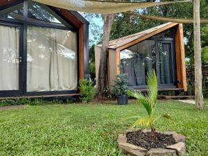 a house with a plant in front of it at Refugios de Rio Ilo in Concepción del Uruguay